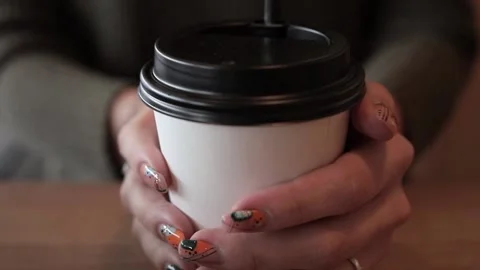 A Cup of coffee in a woman's hands close-up Stock Footage 143309645