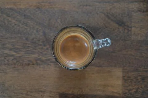 A cup of coffee on wooden table Stock Photos