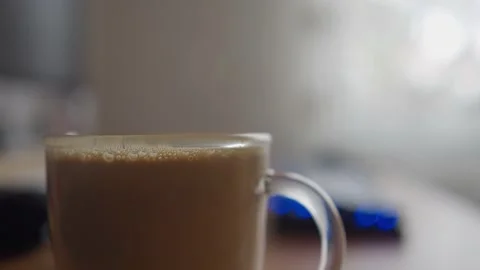 Cup of coffee on a work table and keyboard in the blurry background Stock-Footage 234121679