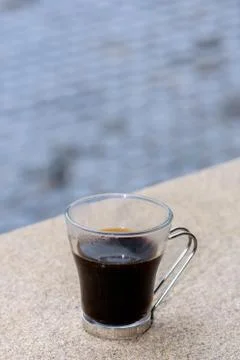 Cup of coffee/tea resting on cliff edge Stock Photos