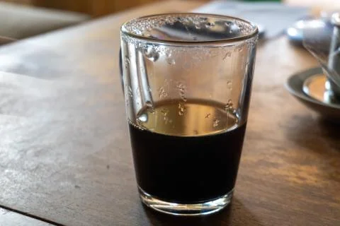 A cup of cold coffee left on the table Stock Photos