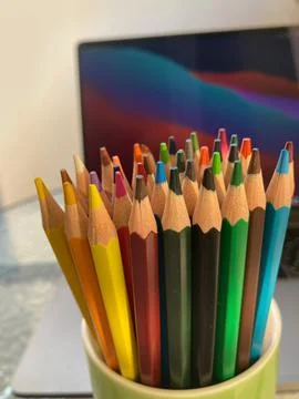 The cup contains a set of colored pencils Stock Photos