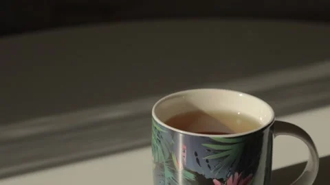 A cup of delicious aromatic hot tea stands on a white table Stock Footage 219508720