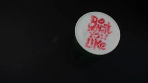 Cup of delicious coffee with words Do What you Like on table Video stock 144063661