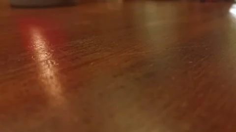 Cup of dice being turned over onto a wooden interior table during a board Stock Footage 174808164