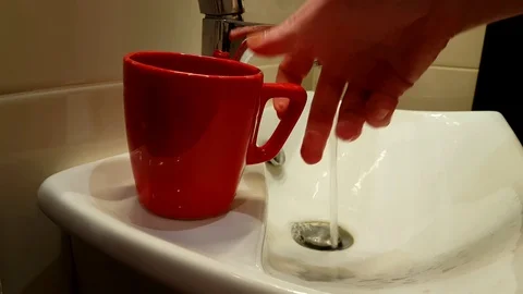 Cup to draw water from a tap Stock Footage 89766049