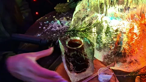 Cup with drink on carved ice table at the International Ice Sculpture Festival Vídeo Stock 331166095