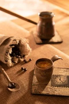 Cup of espresso with beans on table Stock Photos