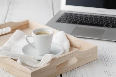 Cup of espresso or coffee resting on a white serving tray Stock Photos