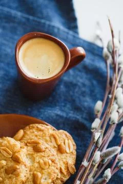 A cup of espresso on a table with cookies Stock Photos