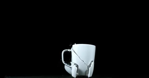 Cup falling and exploding on Black Background 스톡 사진