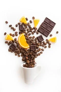 Cup filled coffee beans with chocolate and orange Stock Photos