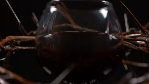 Cup filled with wine surrounded by Jesus crown of thorns while spinning. Stock-Footage 128609033
