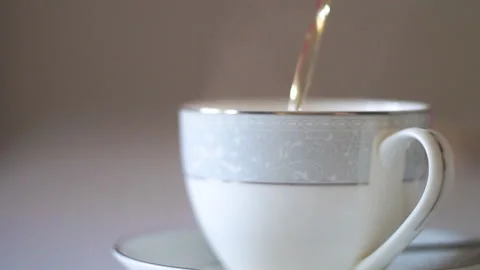 Cup, filling with tea Stock Footage 141385322