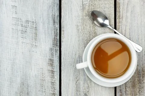A cup of fragrant hot tea on a light background. Herb tea. Hot drink. White.. Stock Photos