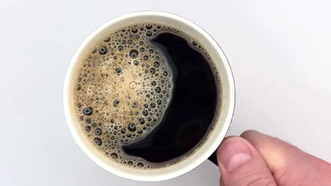 Cup of fresh black aromatic coffee with bubbles, top view, rotate on white Stock Footage 309607706