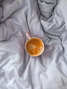 Cup of fresh black coffee on the bed with soft satin linen, 스톡 사진