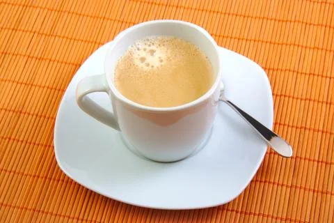 Cup of fresh coffee with spoon on table. Breakfast. Stock Photos