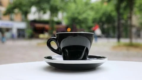 Cup of fresh hot coffee on the table of an outdoor cafe in Paris, France. Stock Footage 316601752