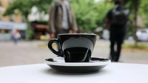 Cup of fresh hot coffee on the table of an outdoor cafe in Paris, France. Stock Footage 316601765