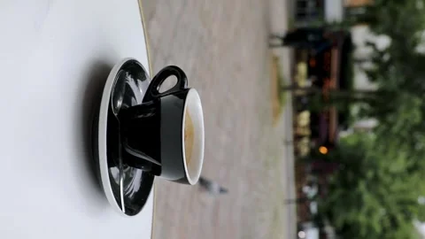 Cup of fresh hot coffee on the table of an outdoor cafe in Paris, France. Stock Footage 316601770