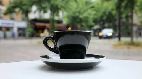 Cup of fresh hot coffee on the table of an outdoor cafe in Paris, France. Stock Footage 316601784