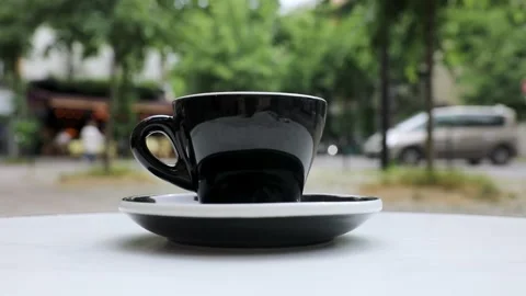 Cup of fresh hot coffee on the table of an outdoor cafe in Paris, France. Stock Footage 316601786