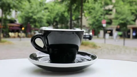 Cup of fresh hot coffee on the table of an outdoor cafe in Paris, France. Stock Footage 316601797