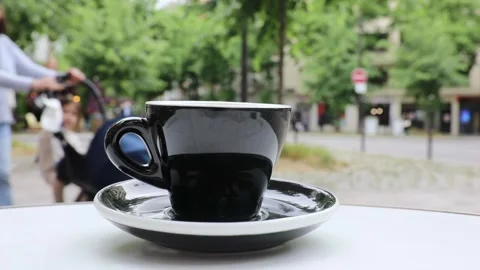 Cup of fresh hot coffee on the table of an outdoor cafe in Paris, France. Stock Footage 316601811
