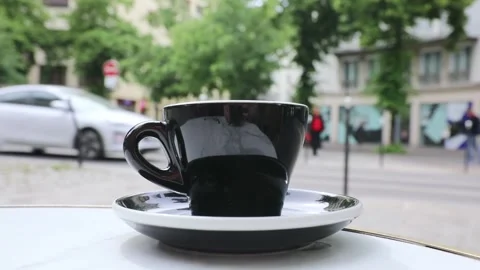 Cup of fresh hot coffee on the table of an outdoor cafe in Paris, France. Stock Footage 316601829