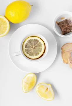 A cup of fresh tea with lemon and ginger. White background, isolated white... Stock Photos