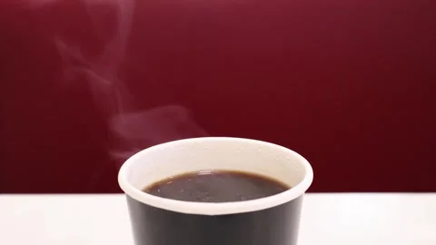 Cup of freshly brewed hot coffee with steam before taken away by man's hand Stock Footage 343944584