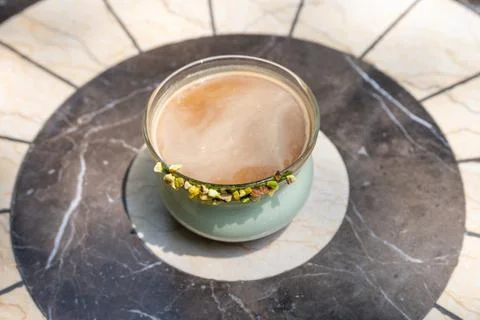 A cup of frothy coffee on a marble table Stock Photos