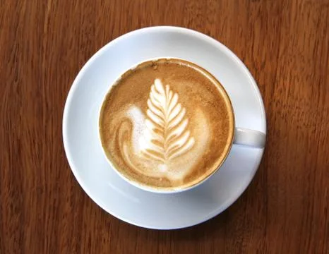 Cup of frothy coffee Stock Photos