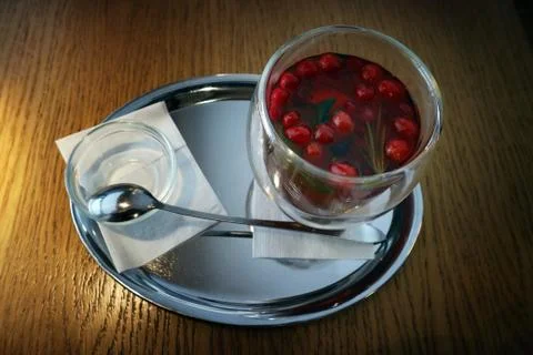 A Cup of fruit tea with berries on the table top view. Stock-Fotos