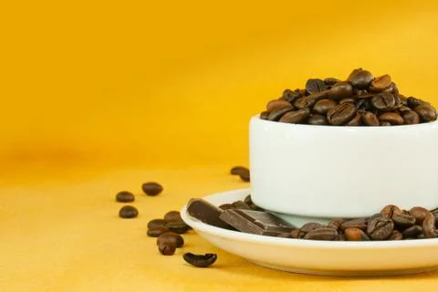 Cup full with coffee beans Stock Photos