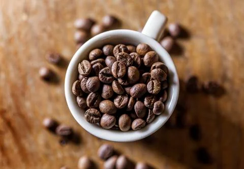 Cup full of coffee beans Stock Photos