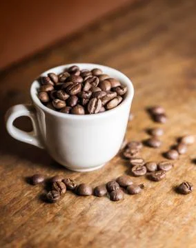 Cup full of coffee beans Stock Photos