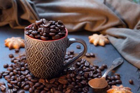 Cup full of coffee beans Stock Photos