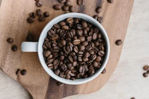Cup full of coffee beans Stock Photos