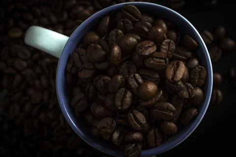 Cup full of coffee beans Stock Photos
