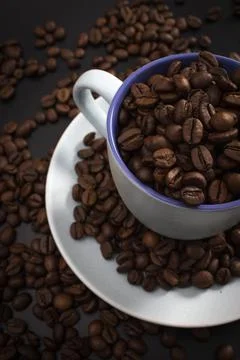 Cup full of coffee beans Stock Photos