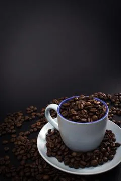 Cup full of coffee beans Stock Photos