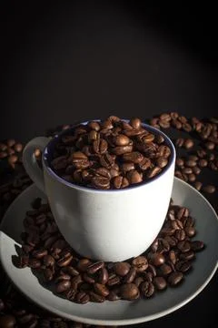 Cup full of coffee beans Stock Photos