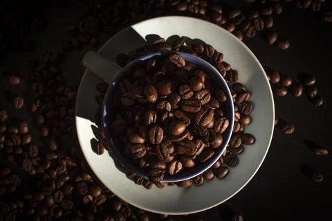 Cup full of coffee beans Stock Photos