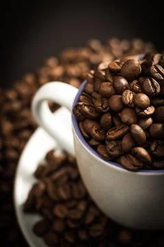 Cup full of coffee beans Stock Photos