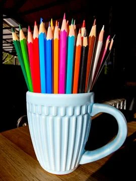 A cup full of rainbow colored pencils. Stock Photos
