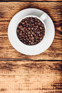 Cup full of roasted coffee beans Stock Photos