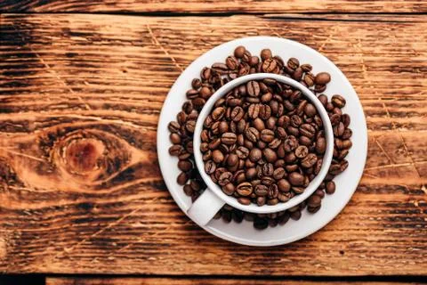 Cup full of roasted coffee beans Stock Photos