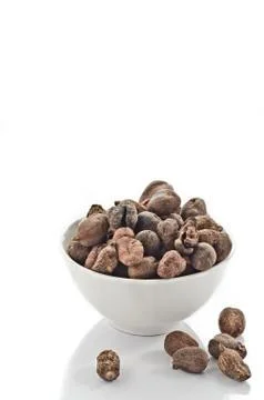 Cup full of shea nuts Stock Photos